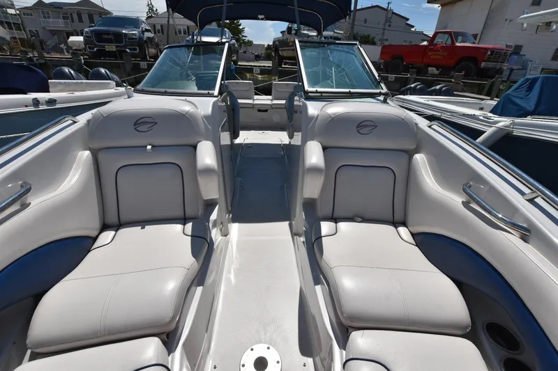 Slide: The Image of 2011 Crownline 265 SS boat interior with white seating and open deck layout. - 7