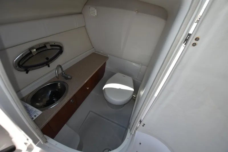 Slide: The Image of 2011 Crownline 265 SS boat bathroom with sink and toilet. - 8