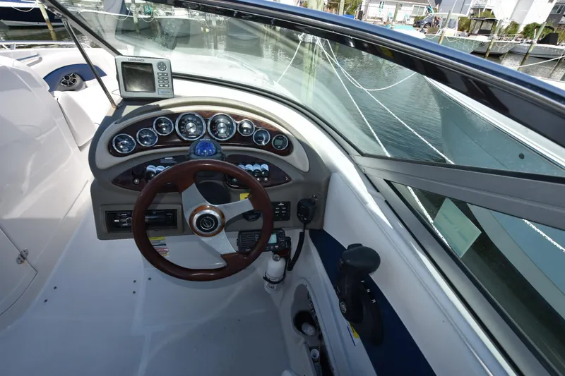 Slide: The Image of 2011 Crownline 265 SS boat dashboard with steering wheel and gauges. - 9