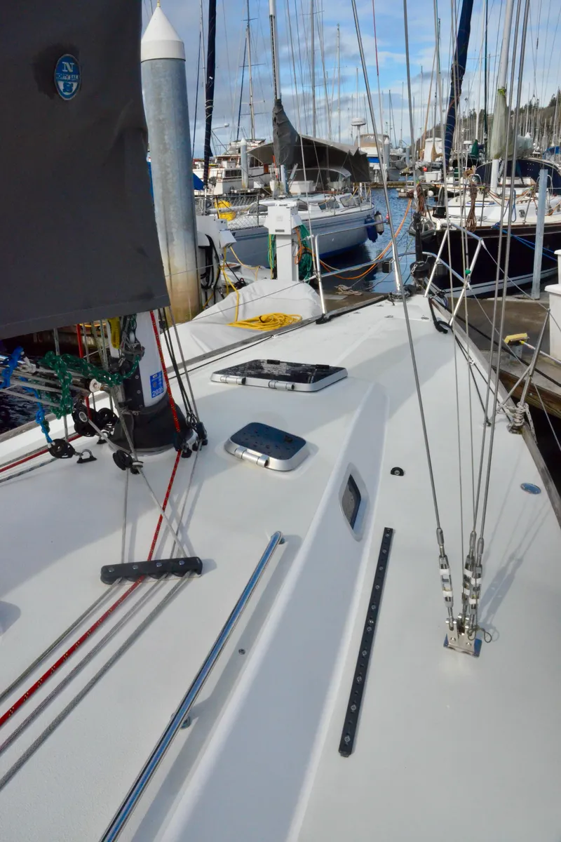 Slide: The Image of 1998 J Boats J/120 sailboat deck view in marina, showcasing rigging and equipment. - 11