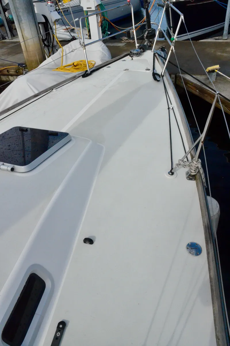 Slide: The Image of 1998 J Boats J/120 sailboat deck with rigging and hatch, docked at marina. - 12