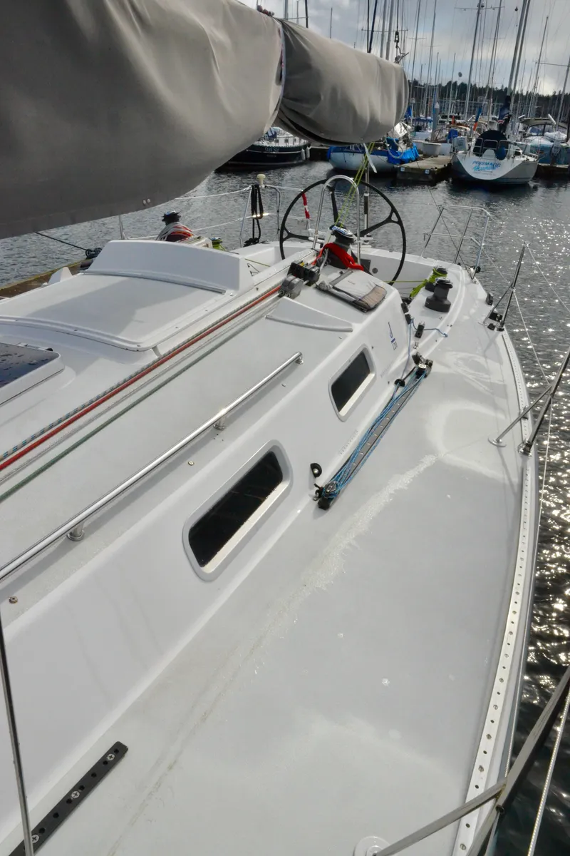Slide: The Image of 1998 J Boats J/120 sailboat docked, showcasing sleek deck design and rigging. - 16