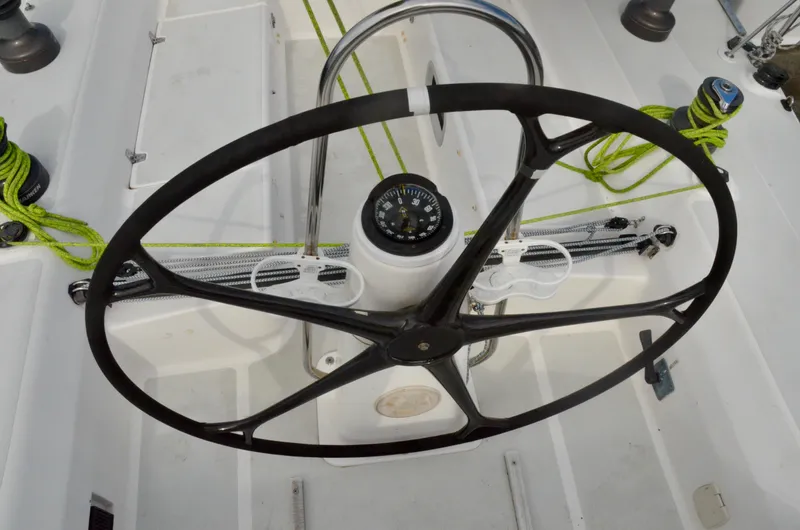 Slide: The Image of Steering wheel and compass on 1998 J Boats J/120 sailboat deck. - 19