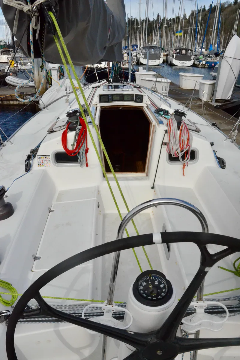 Slide: The Image of 1998 J Boats J/120 sailboat cockpit with steering wheel and rigging, docked at marina. - 20