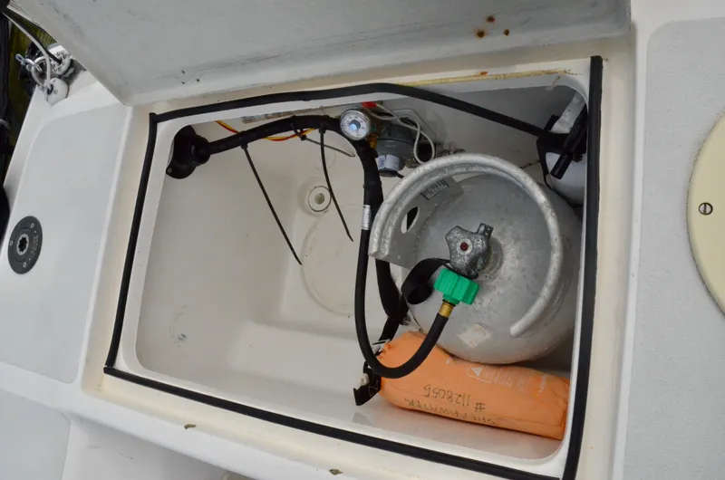 Slide: The Image of Open storage compartment on 1998 J Boats J/120 with propane tank and equipment. - 21