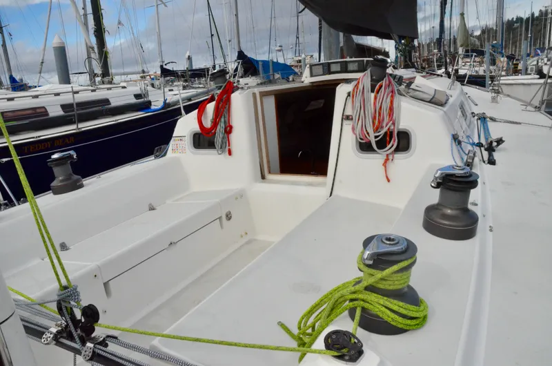 Slide: The Image of 1998 J Boats J/120 sailboat cockpit with ropes and winches, docked at marina. - 23