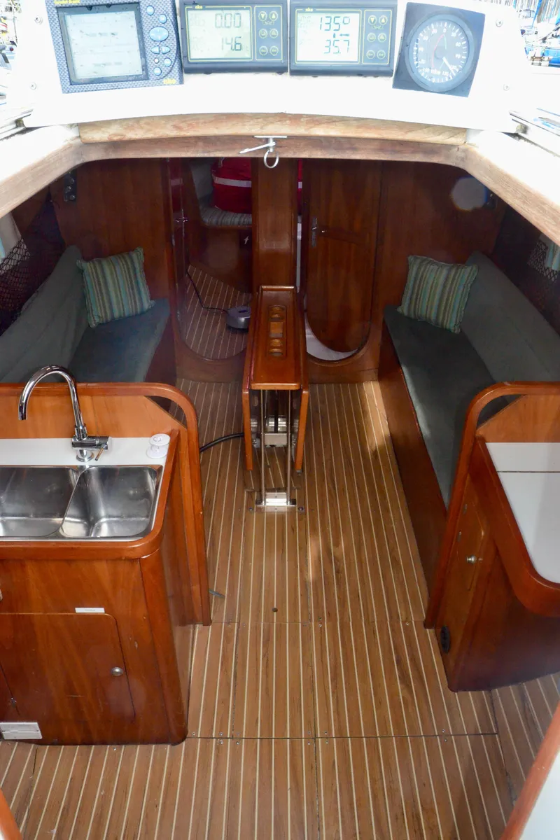 Slide: The Image of Interior of a 1998 J Boats J/120 sailboat with wood finish and navigation instruments. - 25