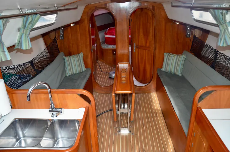 Slide: The Image of Interior of 1998 J Boats J/120 sailboat with wood finish and seating area. - 26