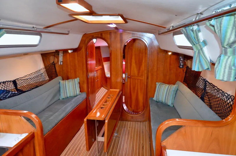 Slide: The Image of Interior of 1998 J Boats J/120 sailboat with wooden finish and cozy seating. - 28