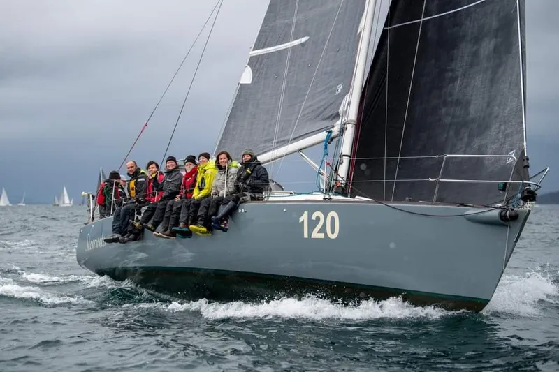 Slide: The Image of Sailing crew on 1998 J Boats J/120 yacht navigating ocean waters. - 3