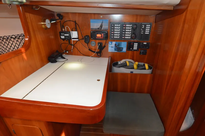 Slide: The Image of Navigation station on 1998 J Boats J/120 sailboat with control panels and equipment. - 30