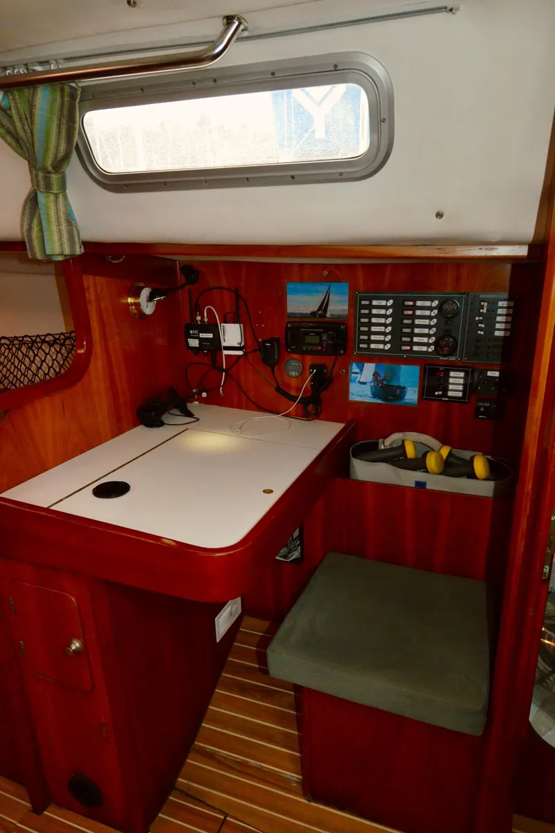 Slide: The Image of 1998 J Boats J/120 navigation station with control panels and seating. - 31