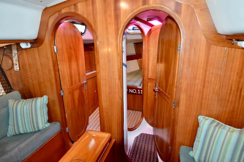 Slide: The Image of Interior of 1998 J Boats J/120 sailboat with wooden doors and cozy seating. - 34