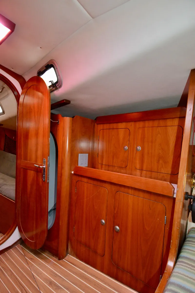 Slide: The Image of 1998 J Boats J/120 interior with wooden cabinetry and open door. - 36