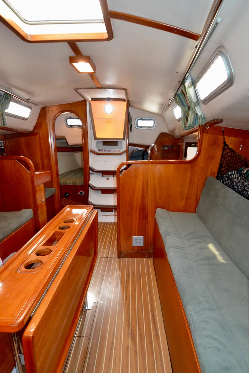 Slide: The Image of Interior of 1998 J Boats J/120 sailboat with wooden finishes and cozy seating. - 42