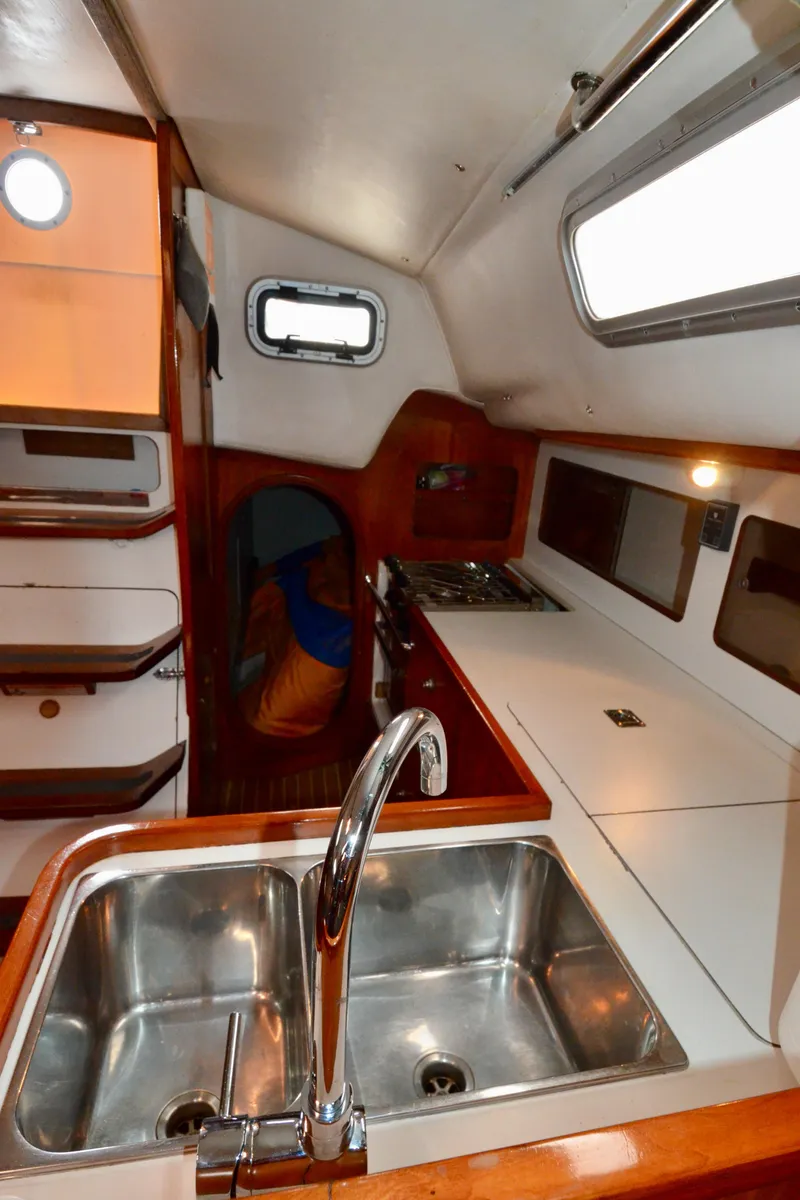Slide: The Image of 1998 J Boats J/120 interior galley with sink, stove, and storage cabinets. - 47