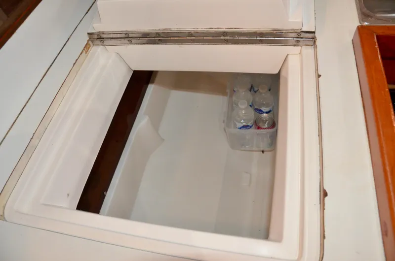Slide: The Image of Built-in cooler with water bottles on a 1998 J Boats J/120 sailboat. - 49