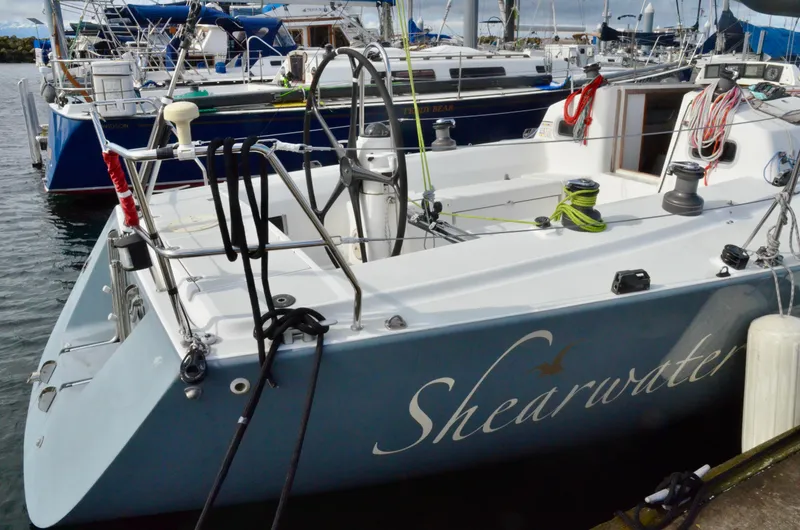 Slide: The Image of 1998 J Boats J/120 sailboat named "Shearwater" docked at a marina. - 7