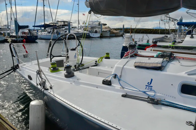 Slide: The Image of Sailboat J/120 from 1998 docked at a marina, showcasing its sleek design. - 8