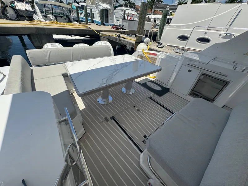 Slide: The Image of 2019 Azimut Verve 40 yacht interior with seating and table, docked at marina. - 17