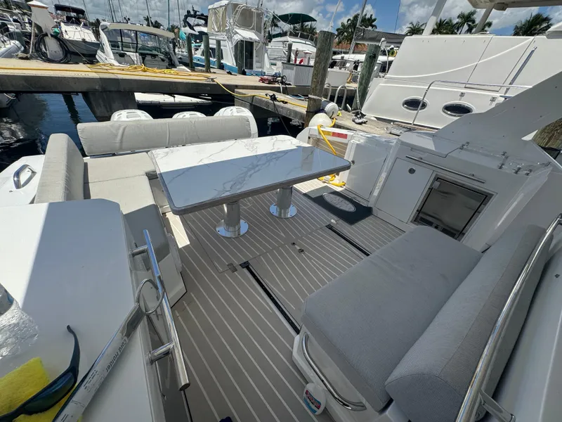 Slide: The Image of 2019 Azimut Verve 40 yacht interior with seating and table, docked at marina. - 18