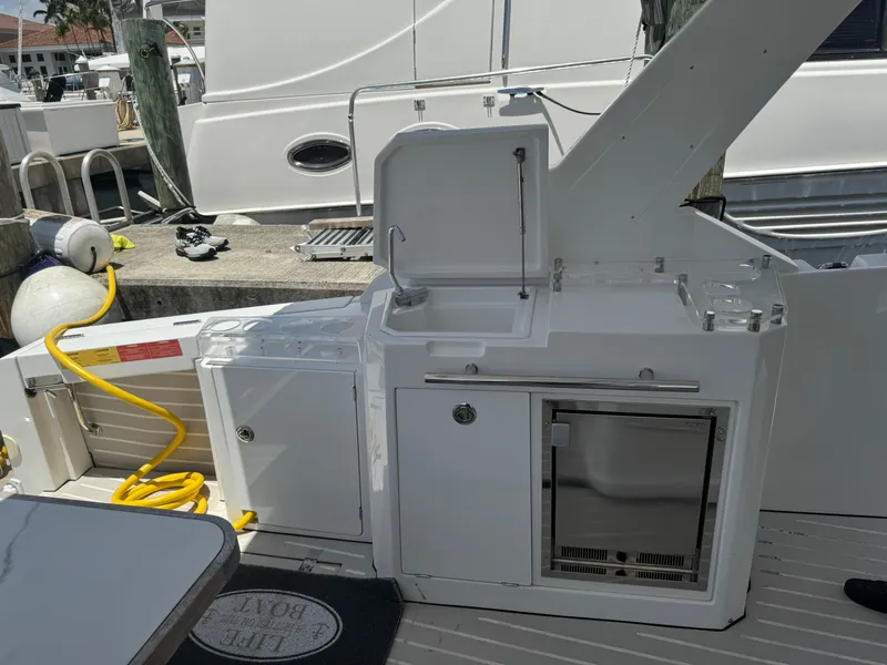 Slide: The Image of 2019 Azimut Verve 40 yacht deck with outdoor kitchen and storage. - 21