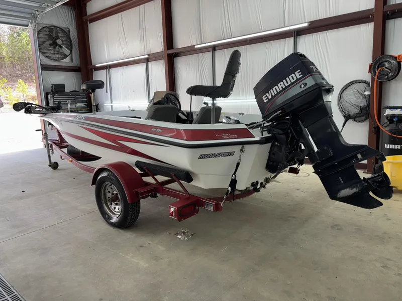 Slide: The Image of 2005 Hydra-Sports Z255 boat with Evinrude motor in a garage setting. - 11