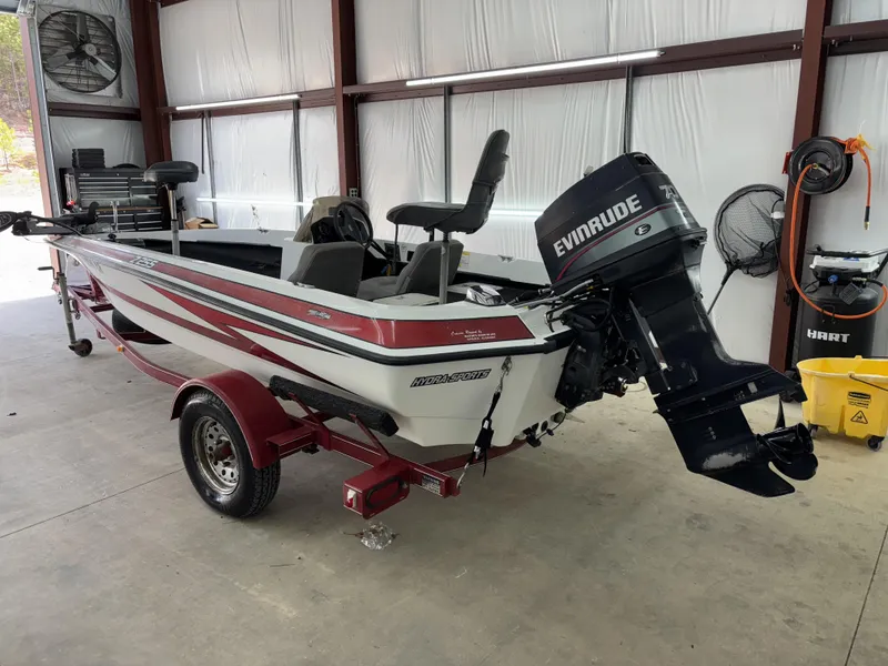 Slide: The Image of 2005 Hydra-Sports Z255 boat with Evinrude motor in a garage setting. - 12