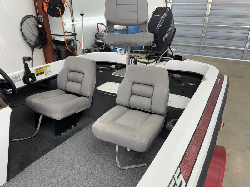 Slide: The Image of 2005 Hydra-Sports Z255 boat interior with gray seats and Evinrude motor in garage. - 6