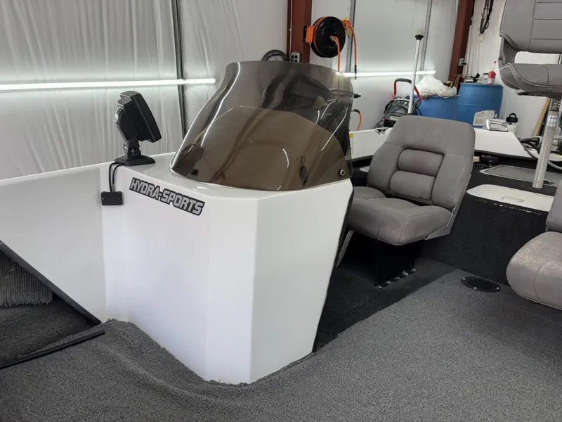 Slide: The Image of 2005 Hydra-Sports Z255 boat interior with console and seating in a garage setting. - 7