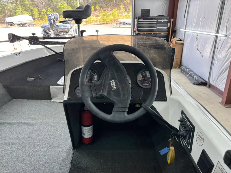 Slide: The Image of 2005 Hydra-Sports Z255 boat dashboard with steering wheel and gauges in a garage setting. - 8