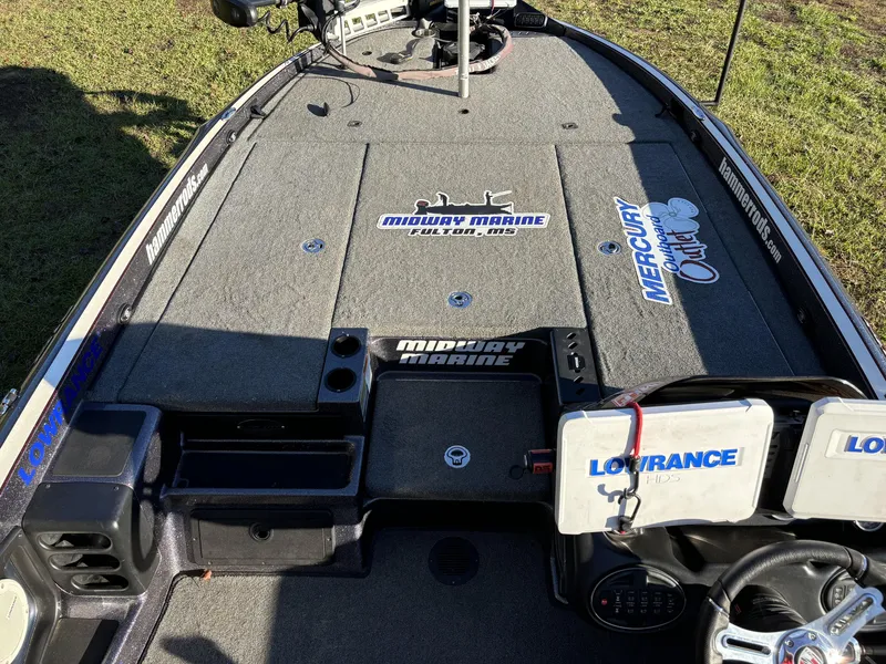 Slide: The Image of 2016 Triton 21 TrX Patriot boat deck with Midway Marine and Mercury decals. - 17