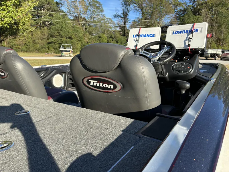 Slide: The Image of 2016 Triton 21 TrX Patriot boat interior with Lowrance electronics and steering wheel. - 6