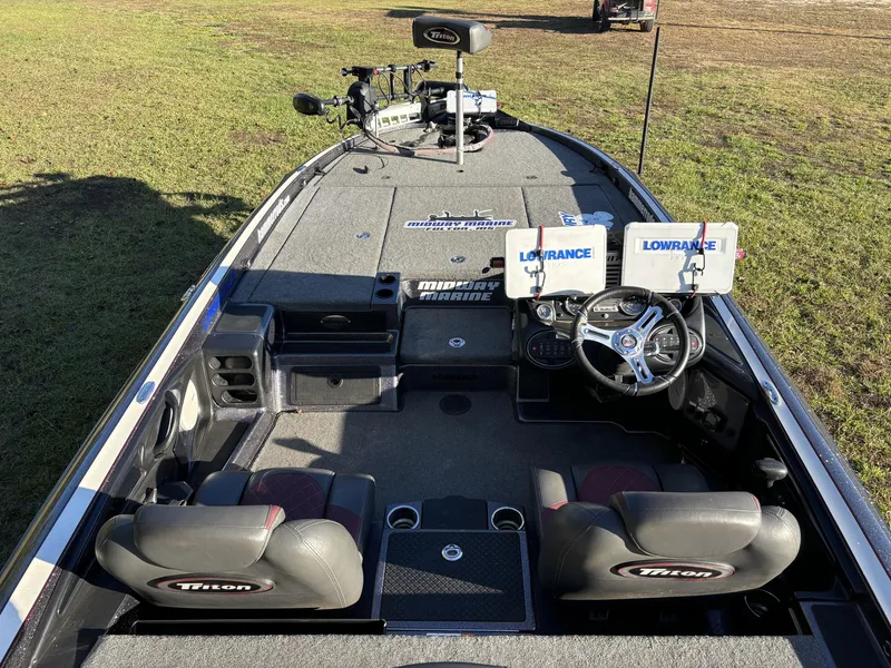 Slide: The Image of 2016 Triton 21 TrX Patriot boat interior with dual Lowrance displays and steering wheel. - 7