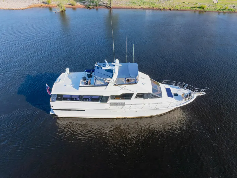 The Image of 1989 Viking 63 Motor Yacht cruising on calm waters, aerial view. - 0