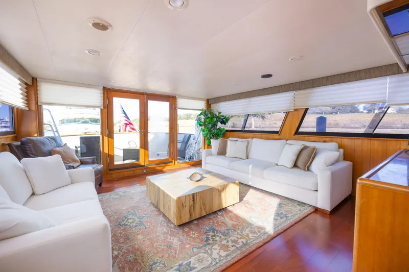 Slide: The Image of Luxurious interior of 1989 Viking 63 Motor Yacht with elegant seating and natural light. - 11