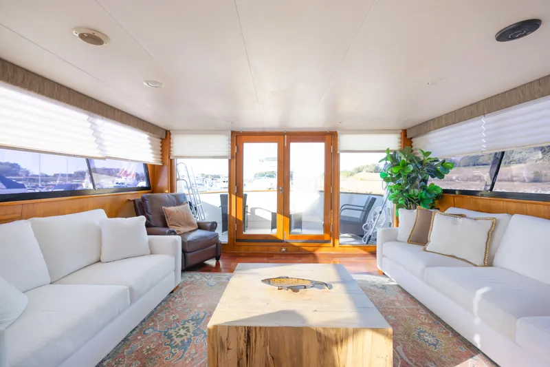 Slide: The Image of Luxurious interior of 1989 Viking 63 Motor Yacht with elegant seating and natural light. - 12