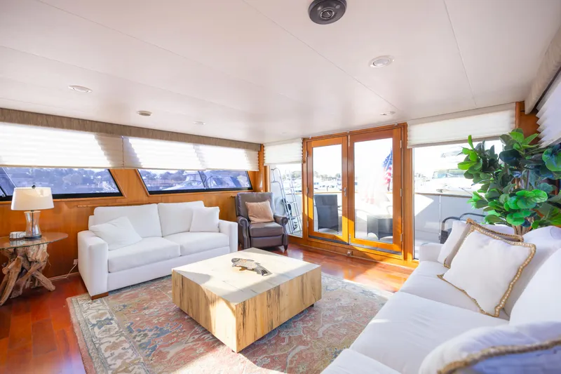 Slide: The Image of Luxurious interior of 1989 Viking 63 Motor Yacht with elegant seating and natural light. - 13