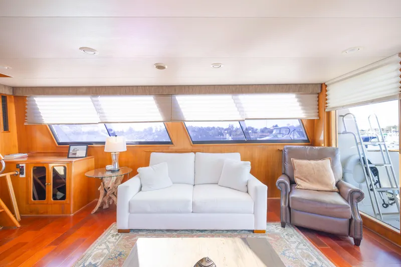 Slide: The Image of Luxurious interior of 1989 Viking 63 Motor Yacht with elegant seating and large windows. - 14