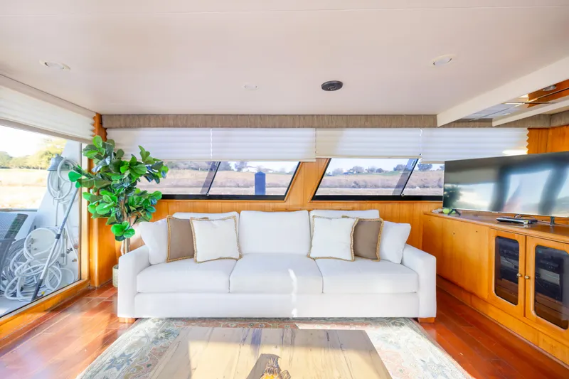 Slide: The Image of Luxurious interior of 1989 Viking 63 Motor Yacht with white sofa and large windows. - 15