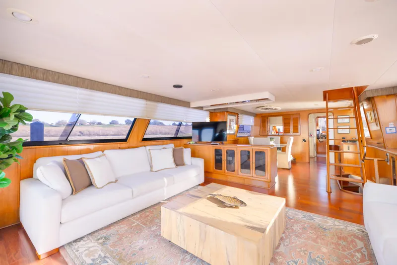 Slide: The Image of Luxurious interior of 1989 Viking 63 Motor Yacht with elegant furnishings and panoramic windows. - 19