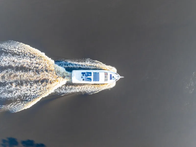 Slide: The Image of Aerial view of 1989 Viking 63 Motor Yacht cruising on open water. - 2