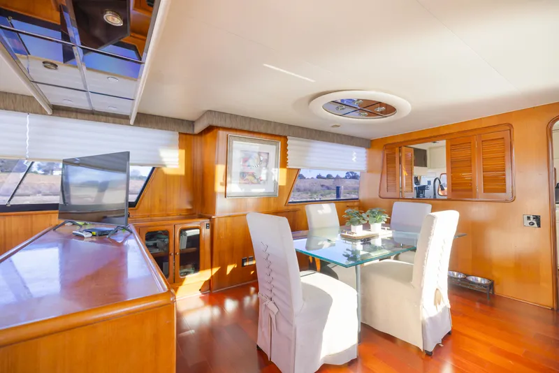 Slide: The Image of Interior of 1989 Viking 63 Motor Yacht with elegant dining area and wooden finishes. - 20