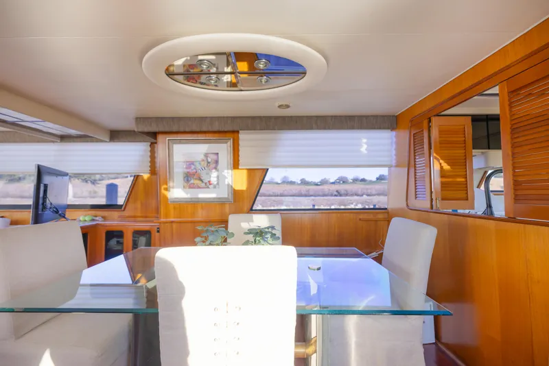 Slide: The Image of Interior of 1989 Viking 63 Motor Yacht with elegant dining area and modern decor. - 22
