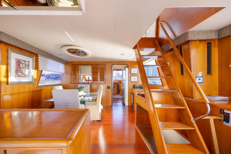 Slide: The Image of Interior of 1989 Viking 63 Motor Yacht with wooden decor and staircase. - 23