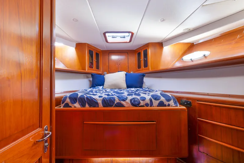 Slide: The Image of Luxurious cabin interior of 1989 Viking 63 Motor Yacht with wood finish and cozy bedding. - 30