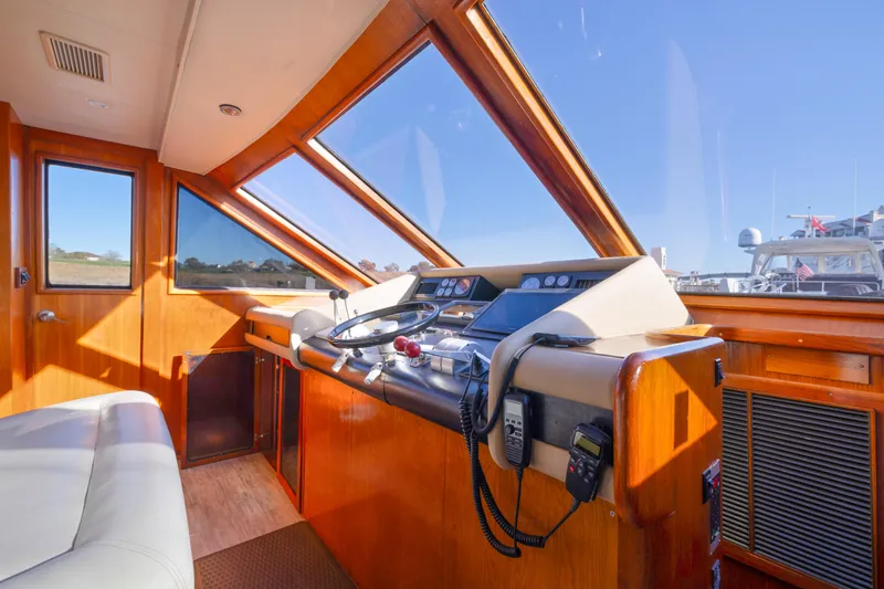 Slide: The Image of 1989 Viking 63 Motor Yacht helm with wooden interior and navigation equipment. - 34