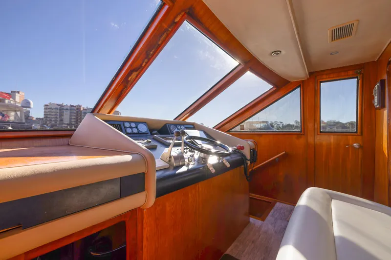 Slide: The Image of Interior helm of 1989 Viking 63 Motor Yacht with wooden finish and panoramic windows. - 35