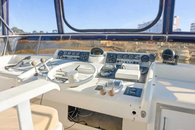 Slide: The Image of Cockpit of 1989 Viking 63 Motor Yacht with steering wheel and control panel. - 41