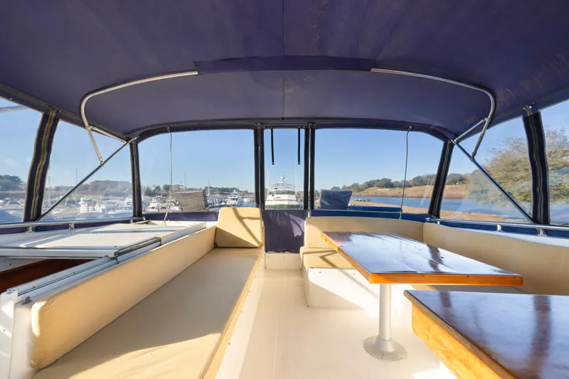 Slide: The Image of Interior view of 1989 Viking 63 Motor Yacht with spacious seating and wooden tables. - 43